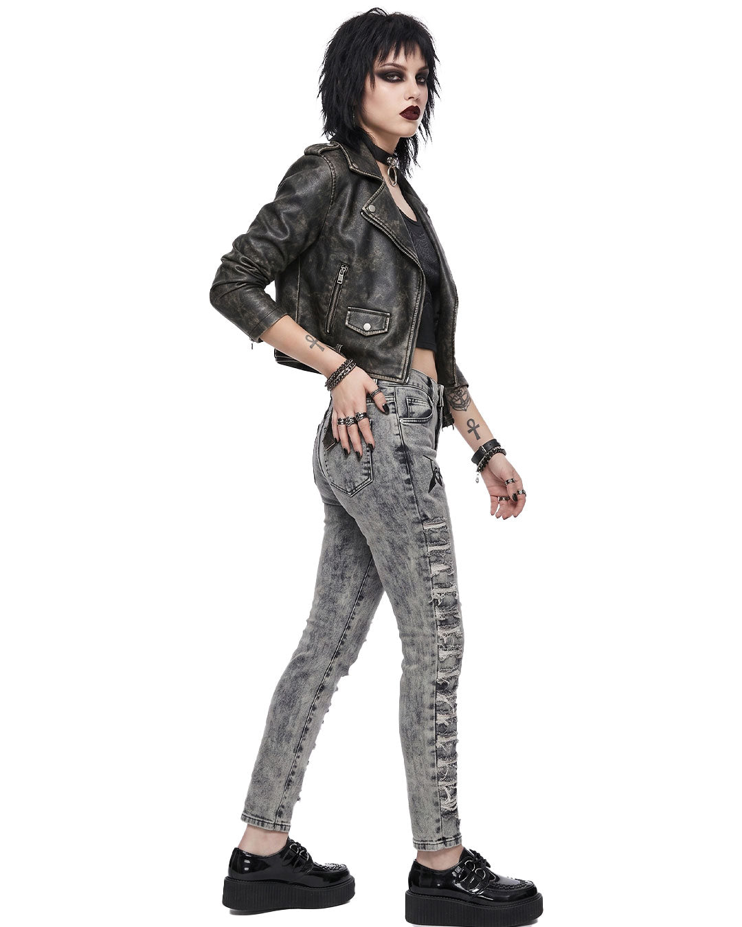 Side view of distressed skinny jeans women showing high-waist fit and frayed vertical thigh rips
