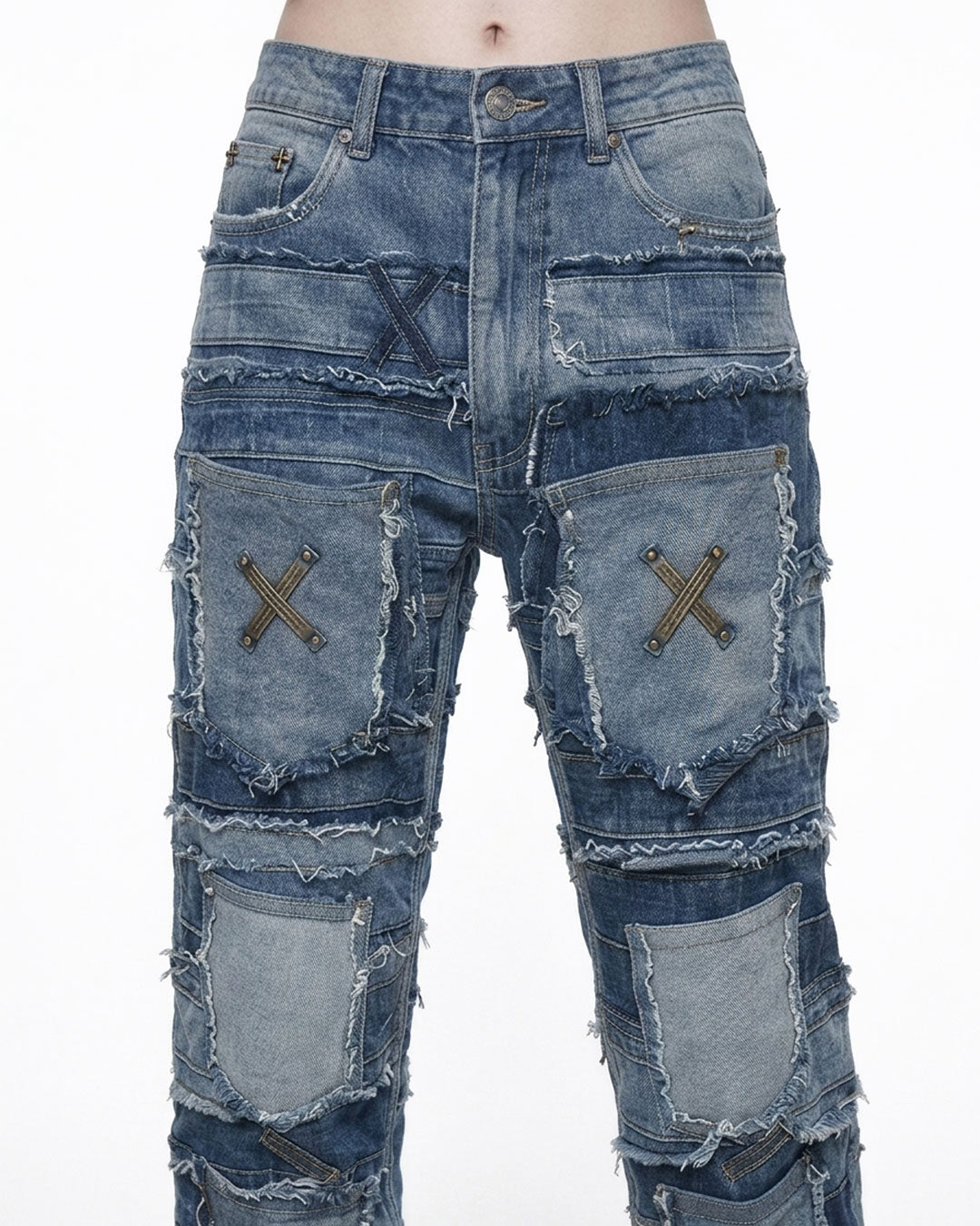  Close-up of patchwork jeans front waist with X-stitched pockets, frayed edges and metal button closure