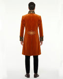 Mens orange coat with black and gold embroidered lapel, cuffs, and long Victorian gothic tailcoat design shown on male model