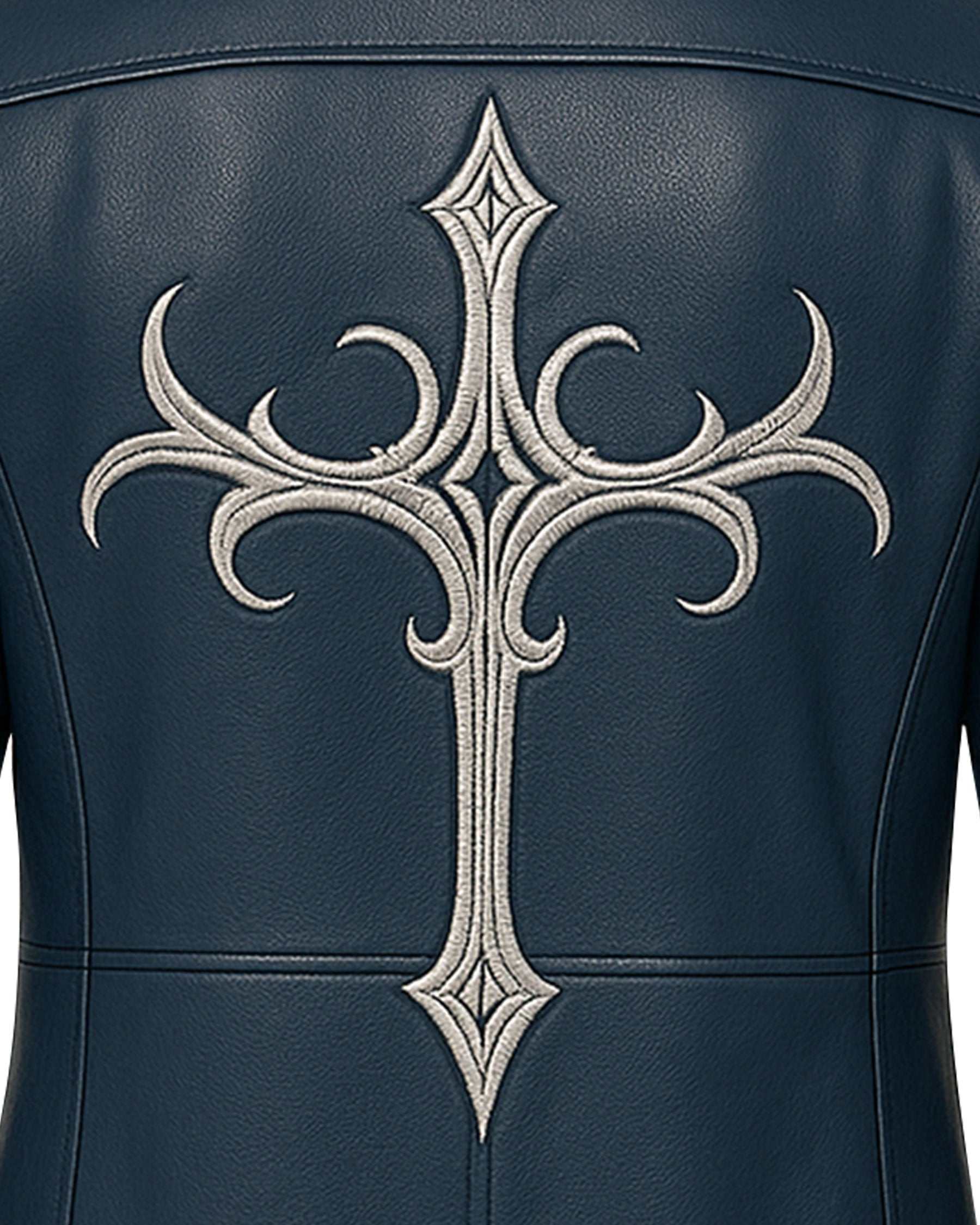 Close-up of silver gothic cross embroidery on the back of a men's blue gothic leather coat