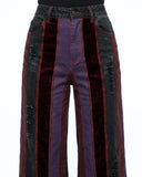 Multicolored striped pants with a mix of purple, red, and black on a white background