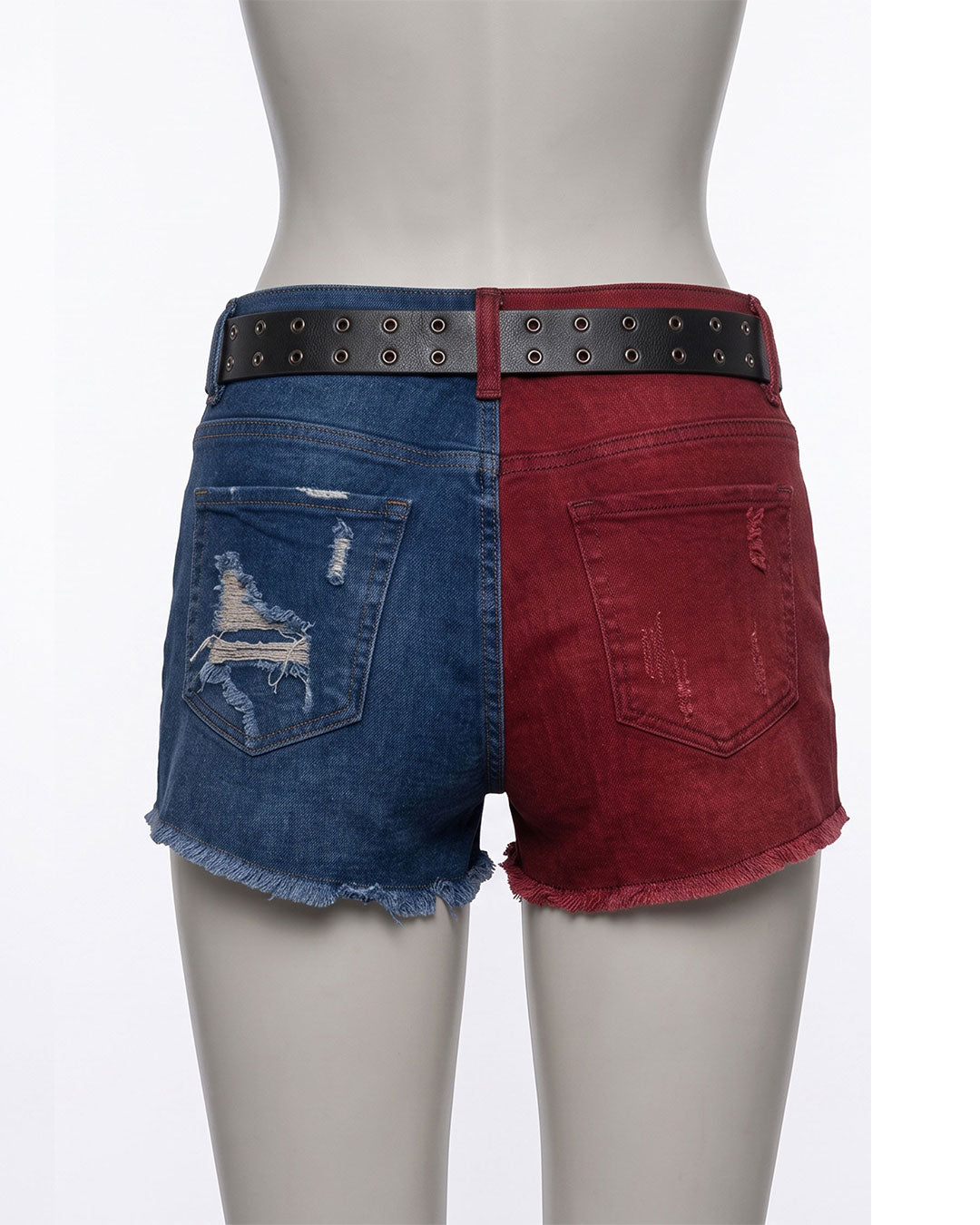 A pair of split-color denim shorts displayed on a gray mannequin from the back. The left side of the shorts is medium blue denim with a distressed patch on the back pocket, and the right side is dark red denim with a matching red back pocket.