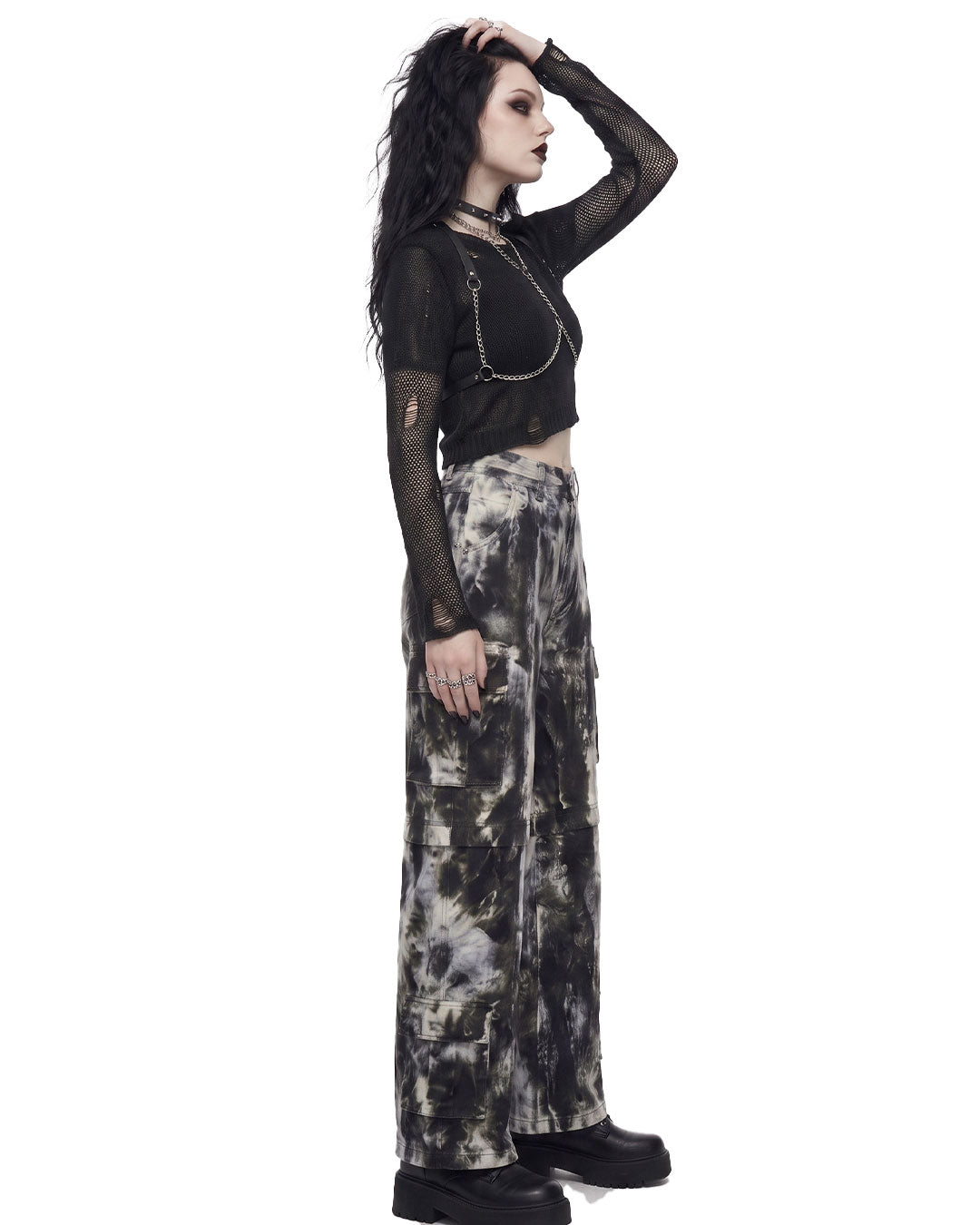 Side view of women’s black and white tie dye wide leg cargo pants showing the wide leg silhouette and cargo pockets.