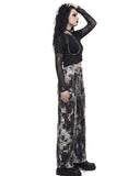 Side view of women’s black and white tie dye wide leg cargo pants showing the wide leg silhouette and cargo pockets.