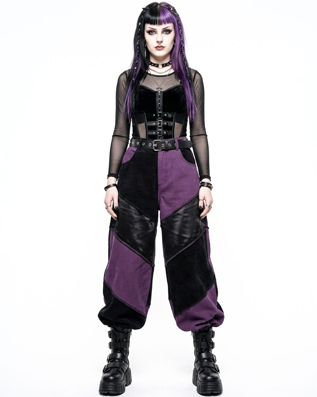 Person wearing a gothic outfit with purple and black colors on a white background
