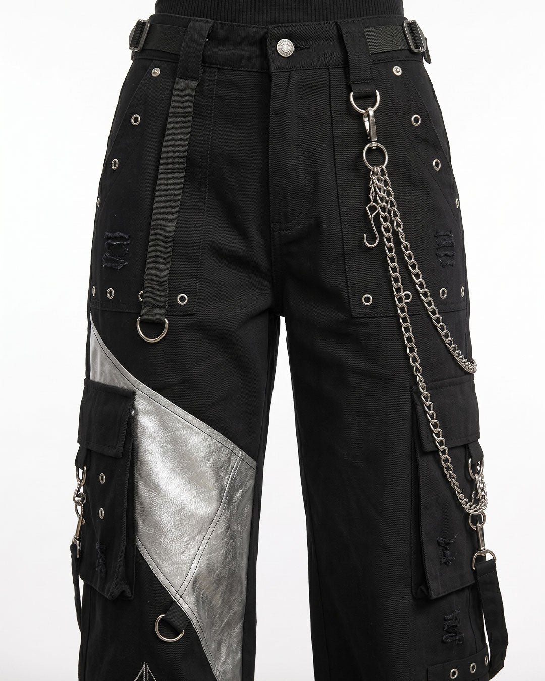 Close-up of black cargo pants women showing premium fabric, metal D-rings, detachable chain, embroidery, and utility pocket details.