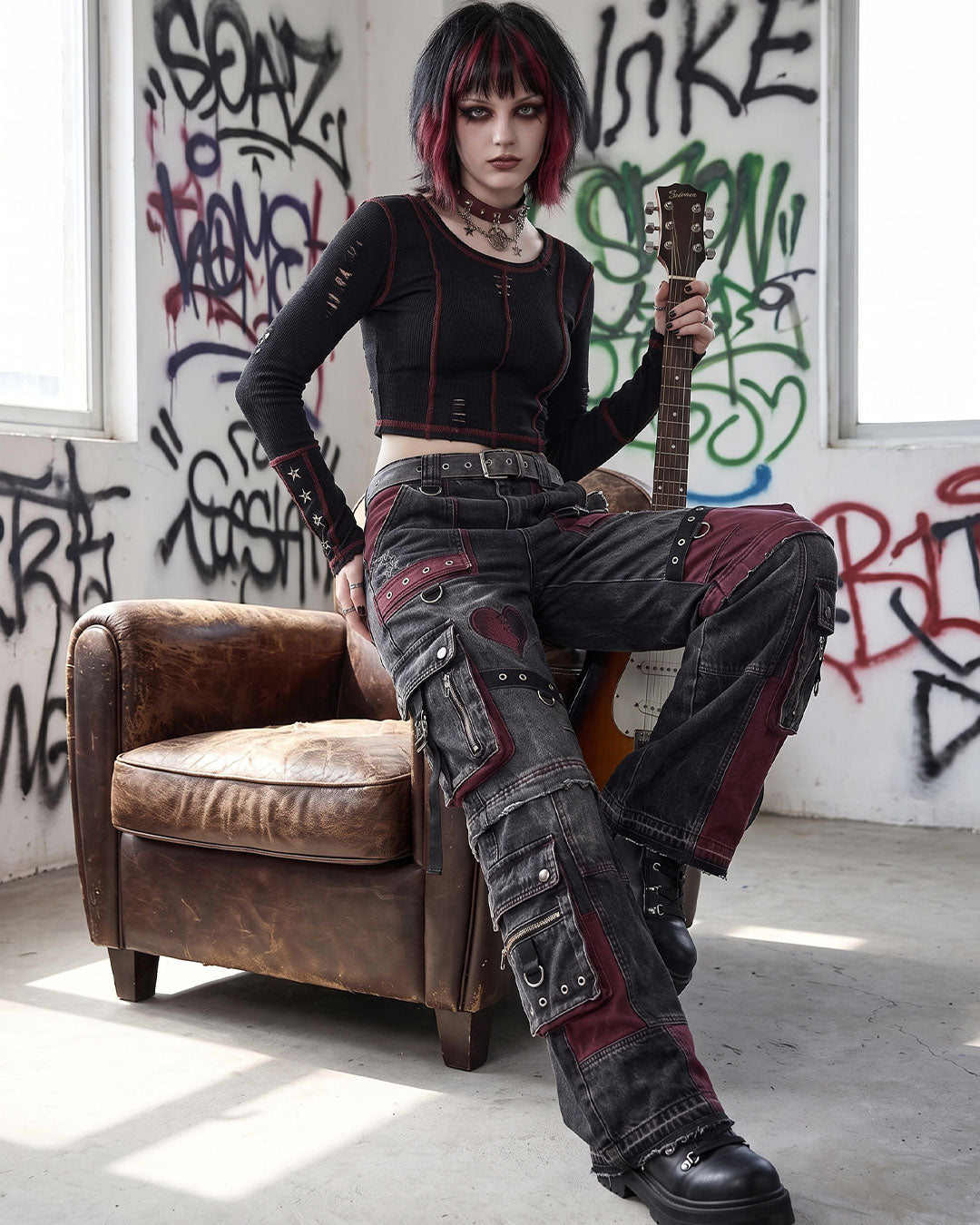 Model sitting while wearing women's cargo jeans with baggy cargo pants fit, highlighting gothic patchwork and utility pocket details.
