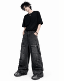 Black baggy cargo jeans for men with oversized fit, washed black denim look, and multiple utility flap pockets in streetwear style.