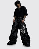 Nightfang men's black gothic leather pants with wide-leg fit and bold front graphic, front view