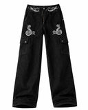 Black cargo jeans for men with baggy wide-leg fit, white graphic detail, and side utility pockets shown in front and back view.
