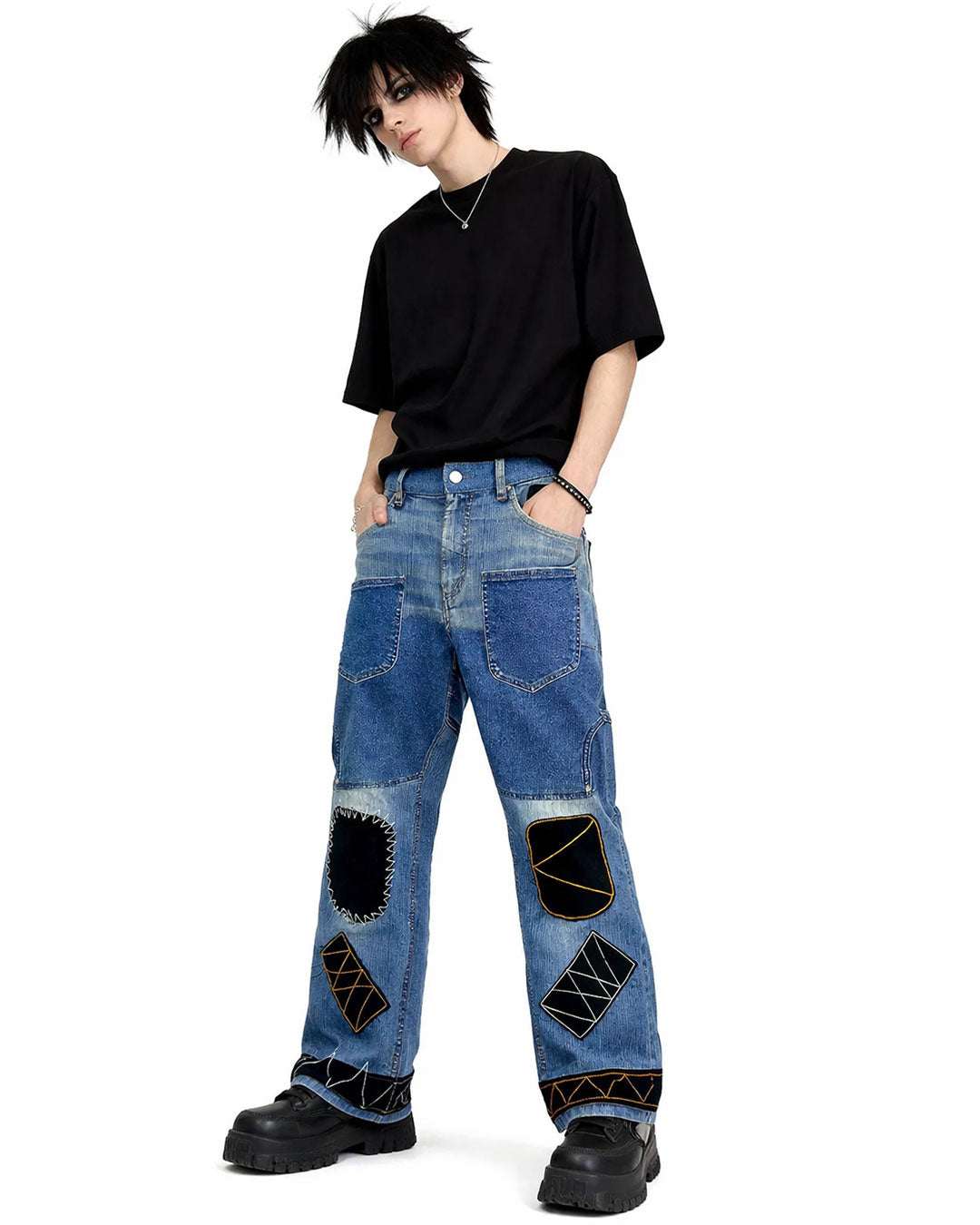 Black patchwork denim jeans with distressed finish, multi-pocket utility design, and wide-leg streetwear fit.