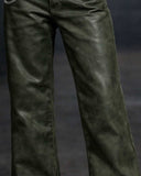 Model wearing green leather suite with cropped jacket and wide-leg trousers in gothic streetwear style